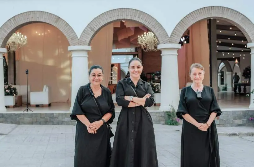 El equipo de Liliana Céspedes abrazando a la novia y acomodando su cola, organización de bodas en Villavicencio